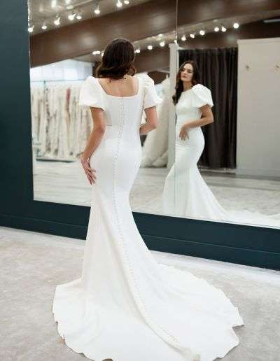 Short sleeve modest bridal gown with train and buttons